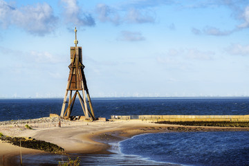 Kugelbake, old sea sign and landmark against the blue sky, symbol of the town Cuxhaven on the North Sea in Germany, copy space