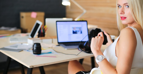 Young photographer and graphic designer at work