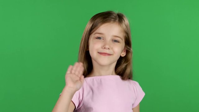 Baby is waving to others. Green screen