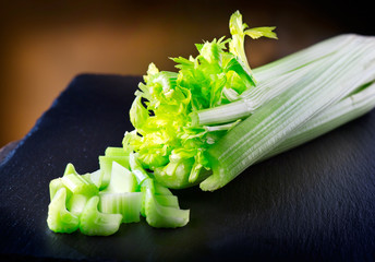 Celery. Closeup of fresh organic green celery on slate table