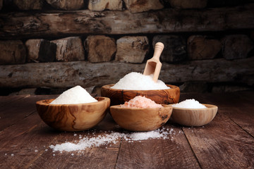 sea salt in bowl. Crystals of salt on table and himalayan salt