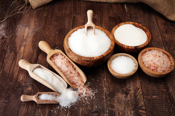 sea salt in bowl. Crystals of salt on table and himalayan salt