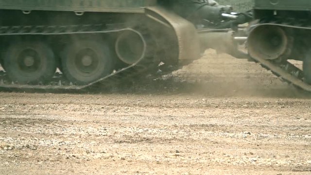 Moving military crawler in the dirt close-up slow motion video