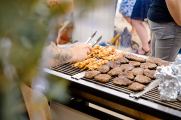 Grilling meat on a bbq during a party