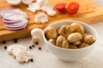 Fried champignon mushrooms in a bowl on the table.