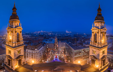 Fototapeta na wymiar Budapest, Hungary - Panoramic skyline view of Budapest from Saint Stephens Basilica at blue hour at winter time with christmas market