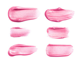 Set of different lip glosses smear samples isolated on white. Smudged makeup product sample.