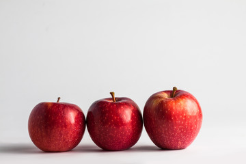 close-up view of fresh red apples on a white background