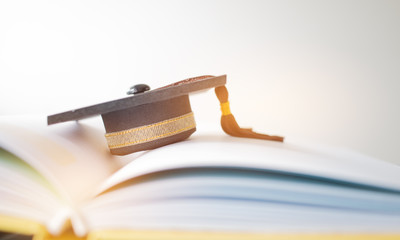 Graduation cap on Books step in Library room of campus and university, Concept of abroad...