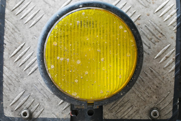 Closeup of retro yellow custom motorcycle headlight, show metal pipe structure
