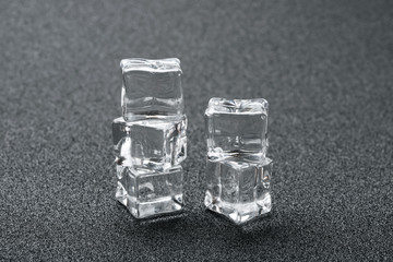 five pieces ice cubes on a dark background