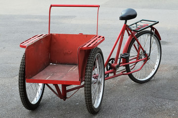 Fototapeta na wymiar Red tricycle bicycle