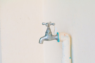 faucet color silver - bronze and old pipe in wall cement background with copy space add text