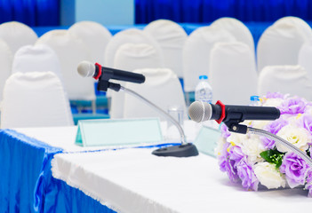 Fototapeta na wymiar microphone wireless on stand table in conference seminar room with copy space add text :Select focus with shallow depth of field.