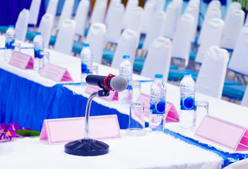 Fototapeta premium microphone wireless on stand table in conference seminar room with copy space add text :Select focus with shallow depth of field.