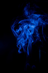 Blue toxic fumes movement on a black background.