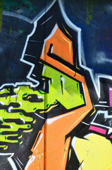 The old wall, painted in color graffiti drawing green aerosol paints. Background image on the theme of drawing graffiti and street art