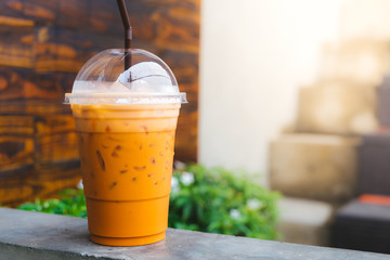 Cold iced Thai Tea, wooden background