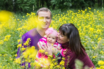 Dad, mom and little baby in the Park