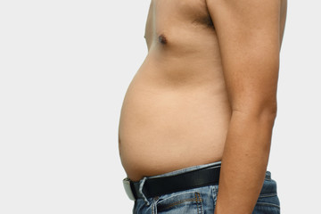 Naklejka premium Asian fat man has cholesterol . He shows excess fat of the tummy. By pointing at the his tummy. / Photo concept: fat, belly, obesity, cellulite