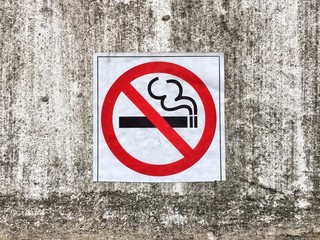 No smoking sign on concrete wall background