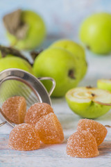  Sweet natural dessert. Apple marmalade and fresh green apples on an old wooden table.