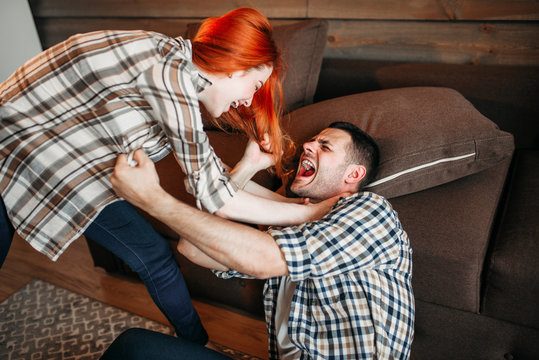 Angry wife beats her husband, domestic violence