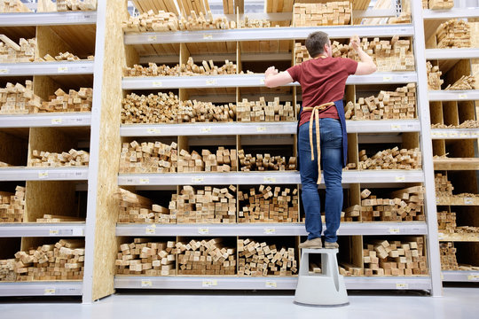 Worker Or Seller In Construction Store Or Warehouse Wood Section At Work