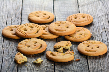 Funny face cookies on wooden background