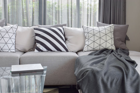 Light gray sofa with varies pattern pillows in modern living corner