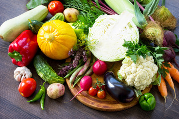 Fresh mixed different vegetables on a wooden oak background. Food background. The concept of a healthy diet.