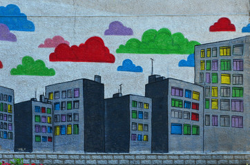 The old wall, painted in color graffiti drawing with aerosol paints. An image of a multitude of skyscrapers with multi-colored windows