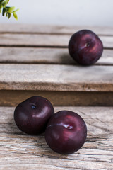 Plums  on the wooden bench