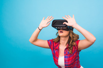 technology, virtual reality, entertainment and people concept - Woman with virtual reality goggles