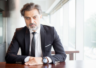 Entrepreneur Sitting at Desk and Looking at You