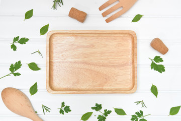 Cooking background with wooden plate from top view
