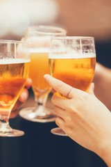 Closeup of Three Glasses of Beer Being Clinked
