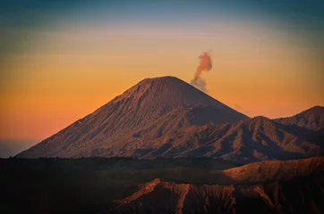 Poster Mount Bromo volcano (Gunung Bromo) at sunrise with colorful sky background in Bromo Tengger Semeru National Park, East Java, Indonesia. © nuttawutnuy