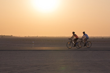 Cycling in the desert at sunset