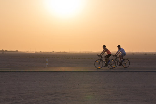 Cycling in the desert at sunset