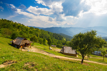Wooden houses on the highland meadow of Carpathian mountains, Ukraine