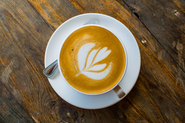 cappuccino cup on the brown wooden table