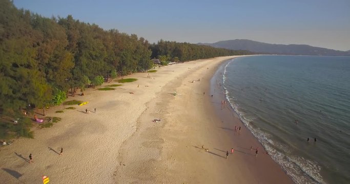 Tree-Fringed Layan And Bang Tao Beach In Phuket, Thailand, Aerial Pullback Shot
