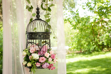Wedding decor, decor in the trees, flowers in black cages