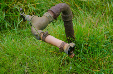 Vintage antique irrigation pipe on ground