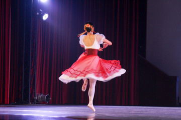 blur movement turning of woman ballerina who wear romantic tutu costume on stage