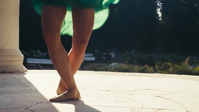 Bare feet of a woman dancing on a stone floor