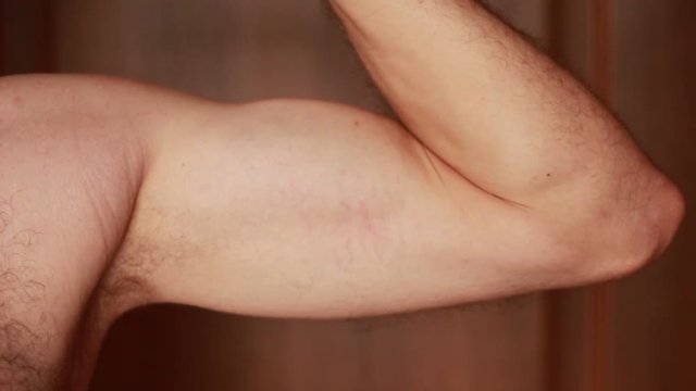 Man flexing biceps closeup