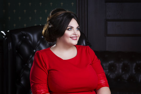 Plus size model, fat woman in red evening dress