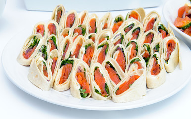 Rolls of thin pancakes with smoked salmon